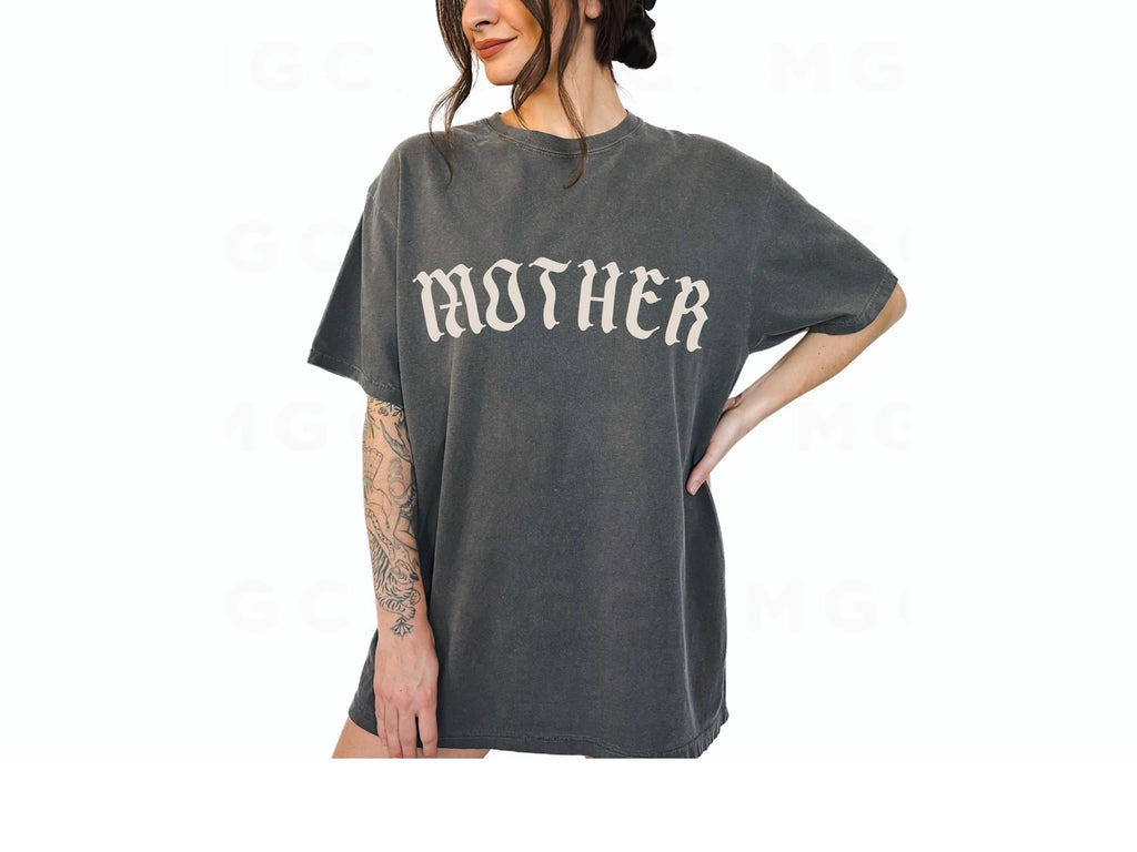 Person wearing a gray oversized t-shirt with 'MOTHER' printed on it, standing against a white background.