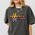 Person wearing a dark gray t-shirt with colorful text design on a plain background